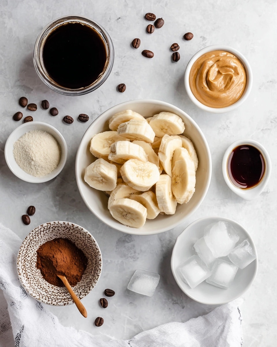 The image shows a white bowl filled with peeled banana pieces placed in the center on a white marbled surface. Around the bowl, there are several small white dishes and bowls containing different ingredients: a small white bowl with ice cubes at the bottom right, a small white cup with dark syrup to the right of the banana bowl, a small white dish filled with creamy peanut butter on the bottom left, a patterned bowl filled with brown cocoa powder with a small wooden spoon inside below the banana bowl, and a small bowl with a powdery white substance to the left. Above and to the left of the banana bowl, there is a glass container filled with black coffee. Scattered around the bowls are a few coffee beans and ice cubes. A white cloth is visible in the upper right corner. Photo taken with an iphone --ar 4:5 --v 7