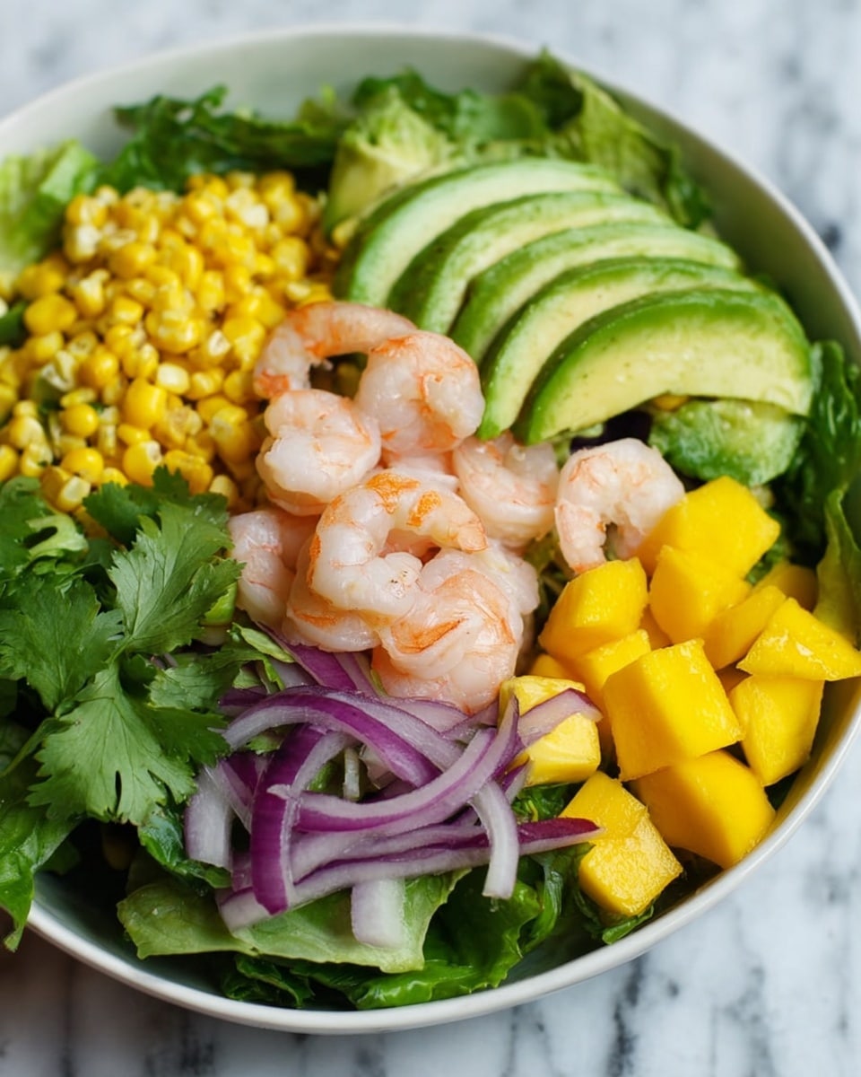 A white bowl sits on a white marbled surface with a light cloth underneath. Inside the bowl, fresh green lettuce forms the base layer. On top, there are bright yellow corn kernels scattered around, with several slices of yellow mango clustered near thin rings of purple onion on one side. A few pink shrimp rest on the lettuce near slices of light green avocado, arranged in a fan shape. Small green herb leaves are sprinkled over the salad, adding extra color and texture. Photo taken with an iphone --ar 4:5 --v 7