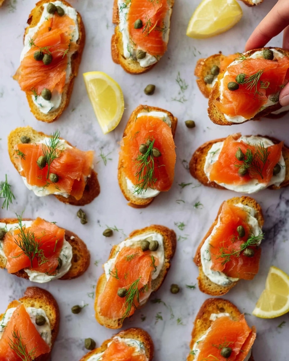 The image shows many small pieces of toasted bread, each topped with layers of bright orange smoked salmon, creamy white dollops of sauce, and green capers. Some toasts also have small green dill sprigs on top. The toasts lie on a white marbled surface scattered with a few lemon wedges, adding a light yellow contrast. A woman's hand is holding one piece of toast to the side. The colors are vibrant with the warm orange of the salmon, fresh green from herbs and capers, and the clean white background and sauce. photo taken with an iphone --ar 4:5 --v 7