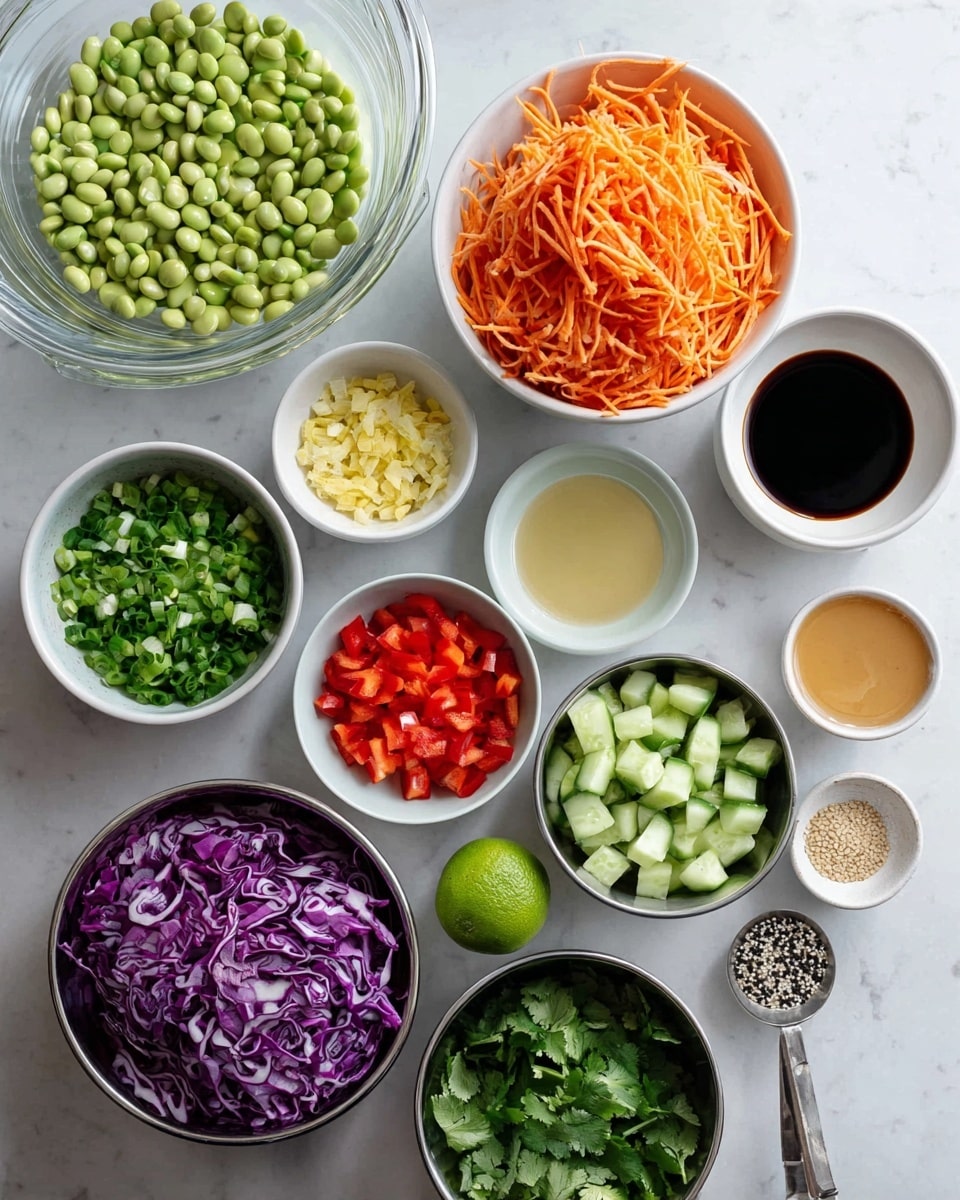 The image shows various ingredients placed in white and metal bowls arranged on a white marbled surface. Starting from the top left, there is a large clear bowl filled with pale green soybeans, next to it a bowl with shredded bright orange carrots. Below the soybeans, chopped green onions sit in a small white bowl, alongside finely minced yellow ginger and light colored shallots in another bowl. Thick chopped purple cabbage is placed in a metal bowl near the center, surrounded by a bowl of chopped fresh green cilantro, bright red diced bell peppers, and medium-sized diced green cucumbers in metal bowls. There are also small white bowls containing light beige sesame seeds and a light brown creamy sauce. Two small bowls hold a clear pale yellow liquid and a dark soy sauce. A fresh whole lime and a silver spoon with a mix of black and white seasoning rest on the surface to the right. The overall look is clean, fresh, and colorful with ingredients spread in neat groups photo taken with an iphone --ar 4:5 --v 7