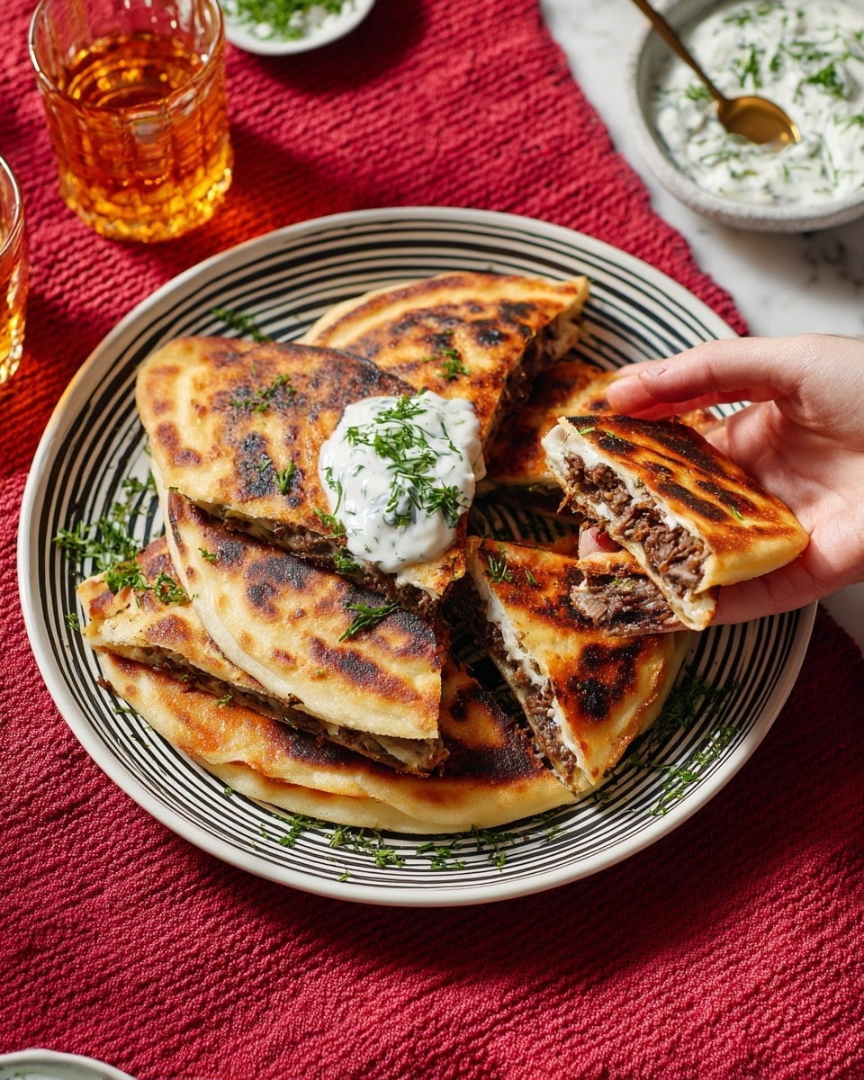 The dish shows six folded flatbreads filled with dark brown meat placed on a white plate with black stripes. Each flatbread has a golden brown and toasted look, with some spots darker from cooking. There is a dollop of white cream with green herbs on top of one flatbread in the center. Scattered green herbs add fresh color on and around the flatbreads. A woman's hand is holding one flatbread on the right side, showing its meat filling inside. Behind the plate, there is a bowl of white creamy sauce with green herbs and a spoon. The whole setup is on a red textured cloth over a white marbled surface. A glass with amber liquid is in the background. photo taken with an iphone --ar 4:5 --v 7