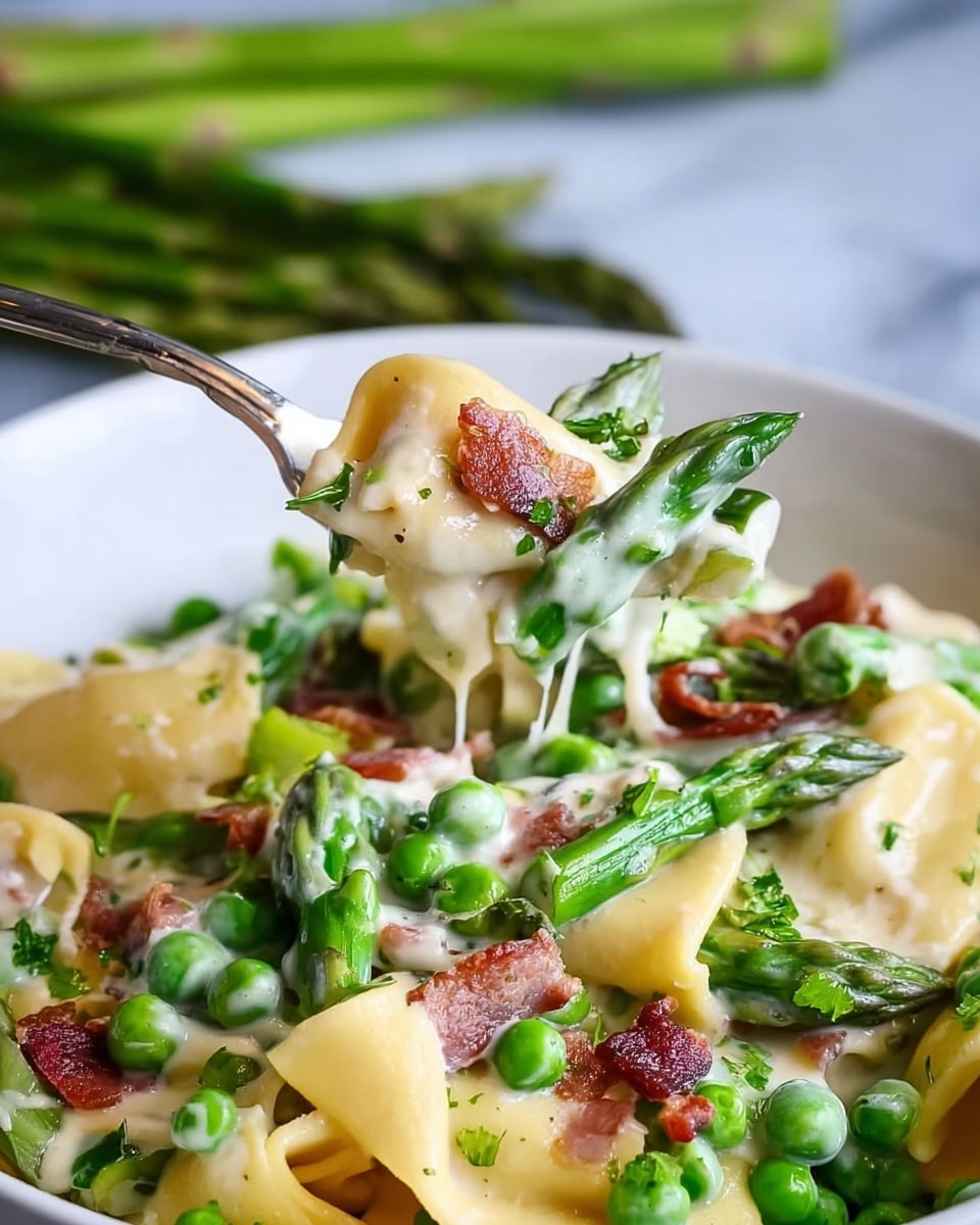 The dish shows a close-up of a white bowl filled with pasta in three layers; at the bottom, there are broad, soft yellow pasta pieces with a smooth texture. Above this, bright green peas and chopped, slightly shiny green asparagus pieces scatter thickly mixed with small strips of reddish-brown bacon. The top layer is covered with a creamy white sauce that coats the pasta and vegetables richly, making everything look soft and moist. A metal fork lifts some pasta and vegetables from the bowl, showing strands of the creamy sauce stretching. The background is white marble with blurred green asparagus stalks. Photo taken with an iphone --ar 4:5 --v 7