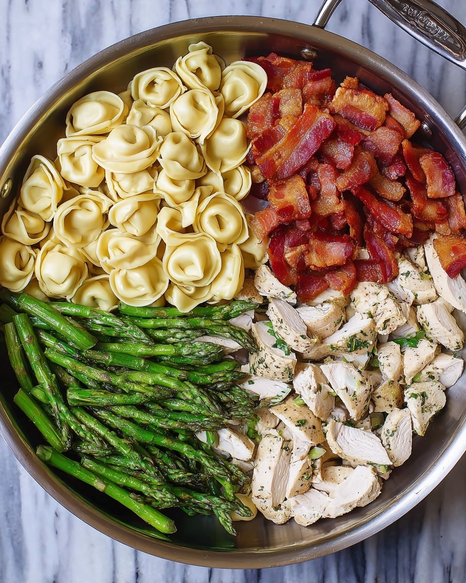 A large stainless steel pan is divided visually into four sections, each filled with a different food. The top left section holds a pile of pale yellow tortellini pasta with a smooth texture. The top right section contains crispy pieces of reddish-brown cooked bacon stacking closely together. The bottom right section features seasoned, sliced white chicken pieces with green herb bits. The bottom left section shows bright green, freshly cooked asparagus spears grouped neatly. The pan rests on a white marbled surface. photo taken with an iphone --ar 4:5 --v 7