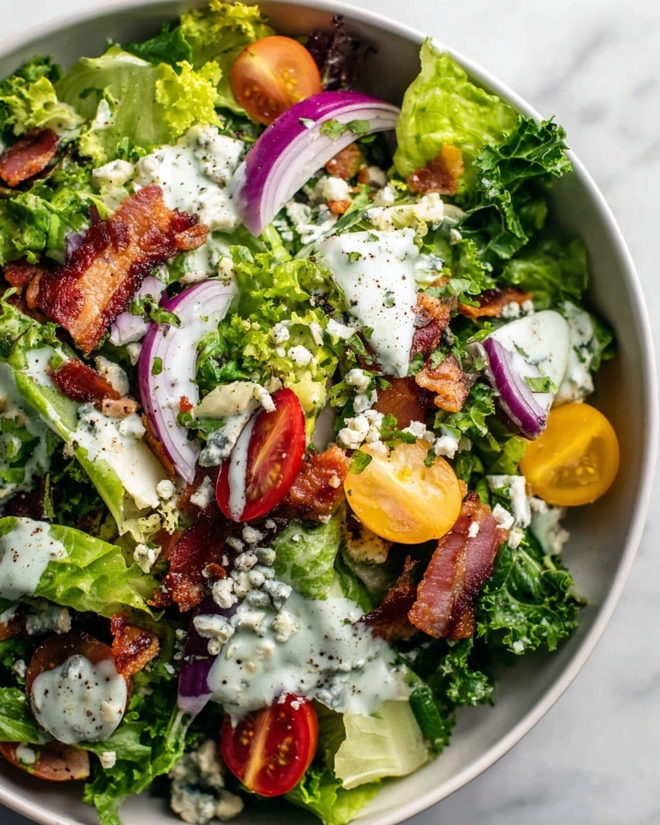 The dish shows a close-up of a fresh salad in a white bowl set on a white marbled surface. The base layer is made of various green leafy vegetables like romaine and kale, mixing bright and dark green colors with different leaf textures. Scattered on top are halved red and yellow cherry tomatoes, thin slices of purple onion, and small chunks of crispy brown bacon. There are also creamy white dressing streaks with green herbs and crumbles of blue cheese spread unevenly across the salad, adding texture and color contrast. The salad is lightly sprinkled with ground black pepper, enhancing the look of freshness and flavor. photo taken with an iphone --ar 4:5 --v 7