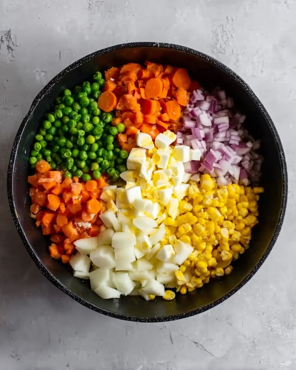 The image shows a black bowl placed on a white marbled surface, filled with six separate layers of chopped ingredients arranged in sections. There are bright green peas in one section, yellow corn kernels in another, orange diced carrots, small white potato chunks, finely chopped purplish-red onions, and chopped boiled egg pieces with white and yellow tones in the center. Each ingredient is clearly separated, revealing a colorful and fresh mix of textures and colors within the bowl. photo taken with an iphone --ar 4:5 --v 7