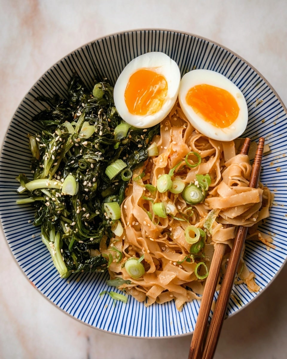 A white bowl with blue vertical stripes holds a dish with three main layers arranged side by side. On the left, dark green leafy vegetables with light green stems are sprinkled with white sesame seeds. In the middle, a soft-boiled egg sliced in half shows a bright yellow yolk surrounded by white. On the right, flat brown noodles mixed with small green onion pieces form the largest portion, with chopsticks resting on top, partly lifting the noodles. The bowl sits on a white marbled surface. photo taken with an iphone --ar 4:5 --v 7