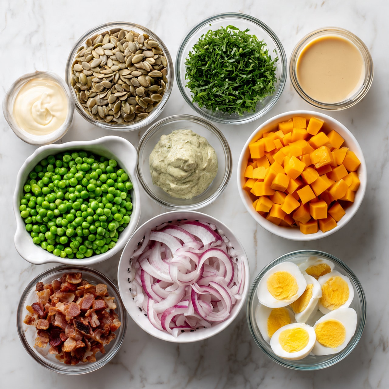 The image shows various ingredients arranged on a white marbled surface, each in separate white bowls or clear glass bowls. Starting from the bottom left, there is a white colander filled with bright green peas. Above this, a clear bowl holds light brown sunflower seeds. Next to it, a white bowl contains chopped fresh green herbs. In the center, a white bowl is filled with thinly sliced white and red radishes. To the right, there are four smaller bowls: one holds finely chopped red onions, another one contains orange cubed butternut squash, the third has chopped crispy bacon, and the last one has chopped hard-boiled eggs with bright yellow yolks. At the top, three glass bowls contain light yellow honey, beige tahini, and creamy white mayonnaise or sour cream. The arrangement is neat, and all items are clearly visible. Photo taken with an iphone --ar 4:5 --v 7