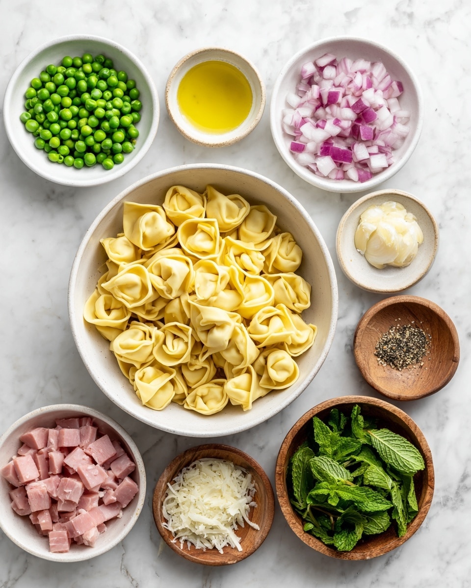 A white bowl filled with uncooked yellow tortellini is placed on a white marbled surface. Surrounding it are eight small white bowls and wooden dishes: one contains diced pink ham, another has chopped red onions, one holds a light yellow oil, another has chopped white garlic, and one holds finely shredded white cheese. A bowl with bright green peas and two wooden dishes with coarse black pepper and salt sit nearby. Finally, a wooden bowl contains fresh green mint leaves. The image is bright and clear, showing all ingredients neatly arranged. photo taken with an iphone --ar 4:5 --v 7