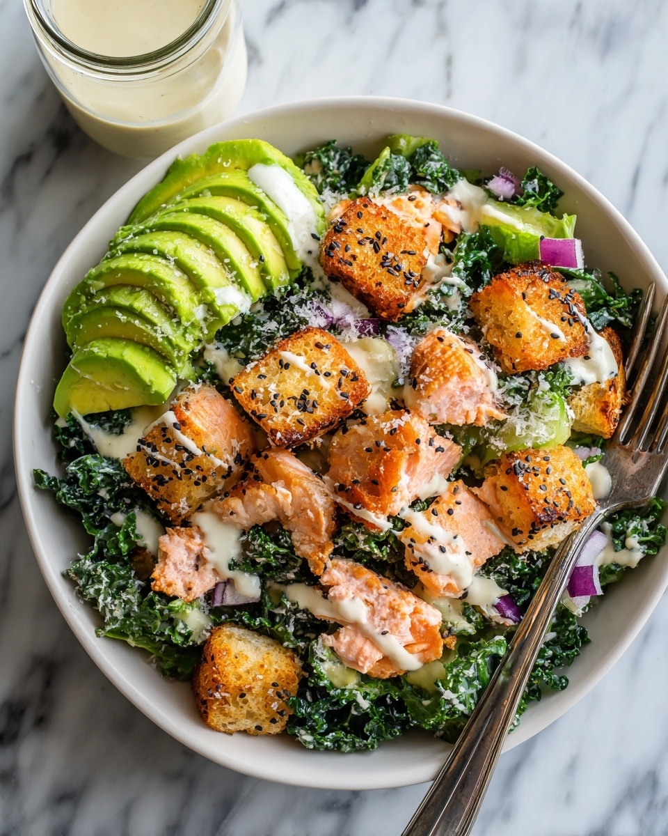 A bowl with a base layer of dark green kale leaves topped with slices of light green avocado arranged on one side. Over the kale, there are pieces of cooked salmon with a light pink and slightly charred orange color scattered around the bowl. Golden brown croutons with black and white sesame seeds are sprinkled on top. Small pieces of red onion add purple spots across the salad. The whole dish is drizzled with creamy white dressing and sprinkled lightly with grated white cheese. A silver fork rests on the right edge inside the bowl. The bowl is placed on a white marbled surface with a jar of dressing beside it on the top left. photo taken with an iphone --ar 4:5 --v 7
