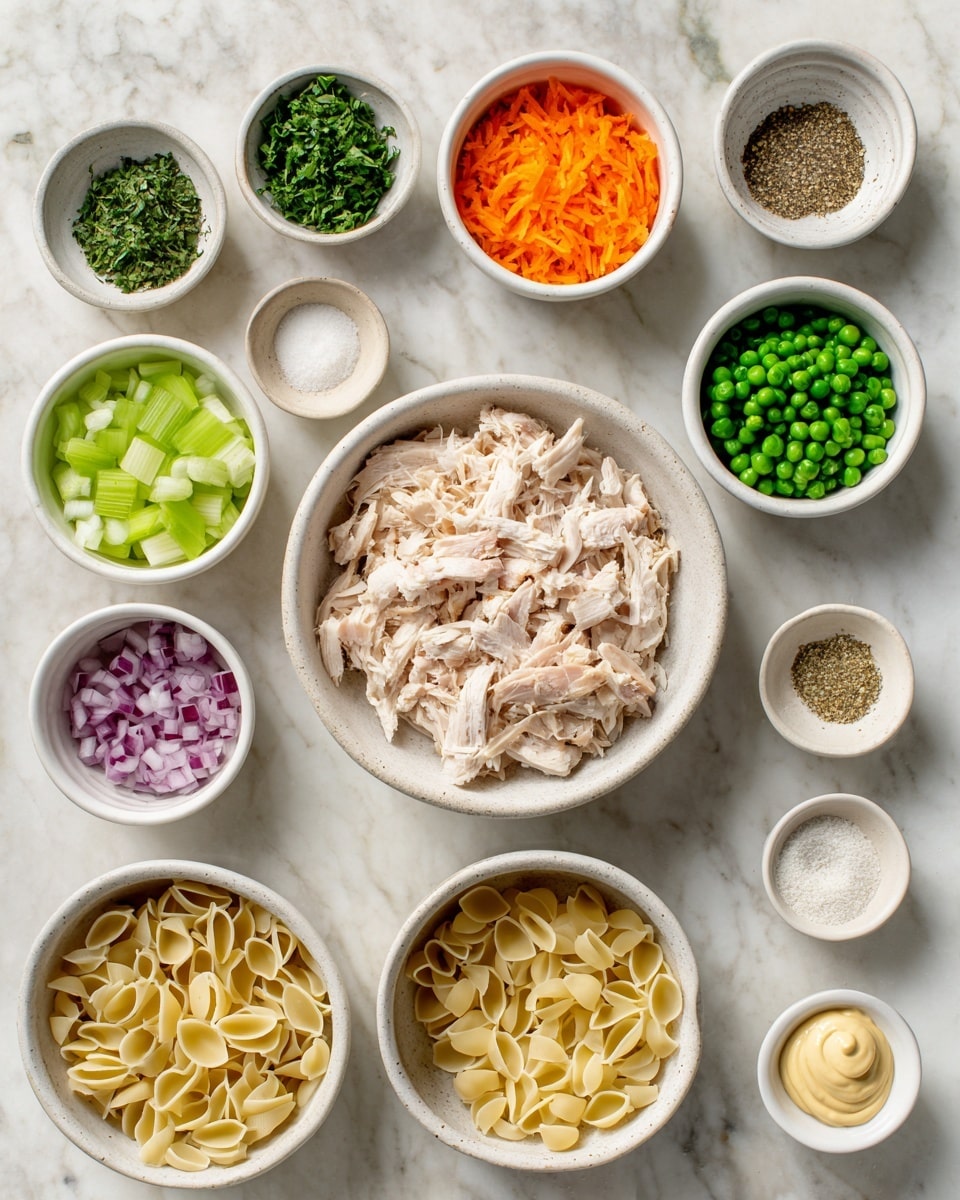 The image shows several small white bowls arranged on a white marbled surface, each filled with different ingredients for a recipe. Starting from the top left, there is a small bowl with green herbs, next to it a bowl with shredded orange carrots. Below that is a bowl with finely chopped red onions, a larger bowl with diced green celery next to it, and a bowl of frozen green peas. In the center is a bigger bowl filled with shredded light beige cooked chicken pieces. To the right of the chicken are various small bowls containing mustard, mayonnaise with a smooth creamy texture, garlic powder, white salt, black pepper, and uncooked pale yellow shell pasta in a large bowl. Every bowl varies in size but all sit neatly spaced out. The overall feel is clean and organized with fresh ingredients ready for use. Photo taken with an iphone --ar 4:5 --v 7
