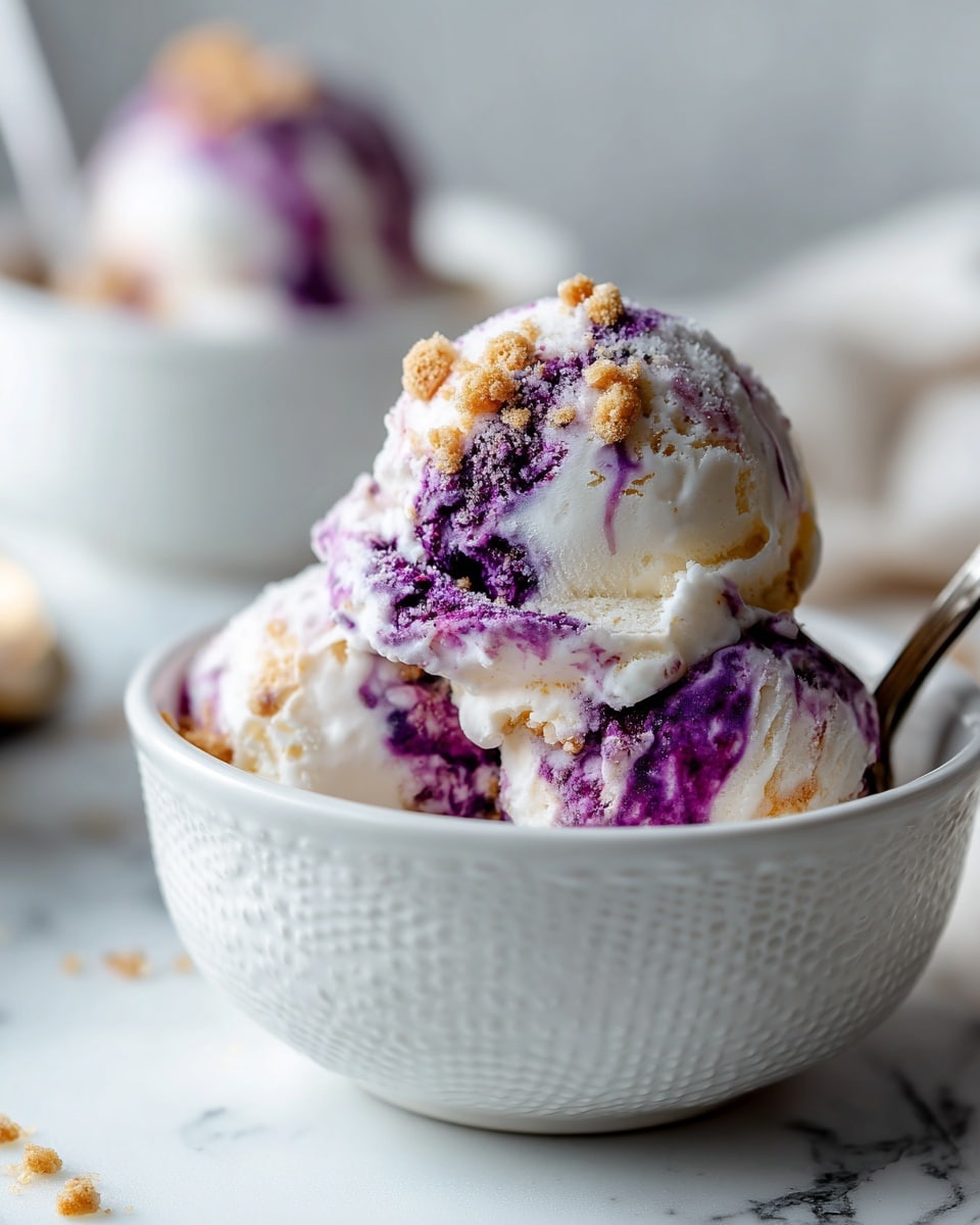 A close-up of a scoop of ice cream in a white bowl with a textured pattern on the outside. The ice cream has a creamy white base with swirls of deep purple, giving a marbled effect. Mixed in are small light brown chunks, adding a rough texture contrast. The ice cream looks soft and slightly melting around the edges. In the background, there is a blurred second white bowl with more ice cream, sitting on a white marbled surface. photo taken with an iphone --ar 4:5 --v 7