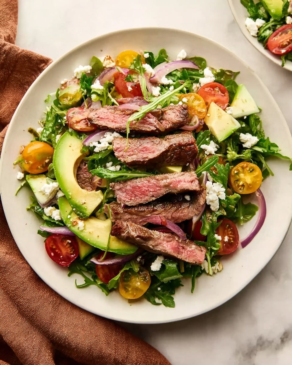 A white plate holds a fresh salad arranged in layers, starting with a base of green arugula leaves that create a lush, textured bed. On top, there are slices of ripe avocado, bright yellow and red cherry tomatoes, and thin rings of light purple onion, all mixed in evenly. Layered above are several strips of cooked steak, showing a warm, pinkish-red center with a browned outer edge, placed spread over the salad. Small crumbles of white cheese are sprinkled across the dish, adding a soft contrast to the colors and textures below. The plate rests on a white marbled surface with a brown cloth nearby, and a woman's hand is slightly visible reaching towards the plate. photo taken with an iphone --ar 4:5 --v 7