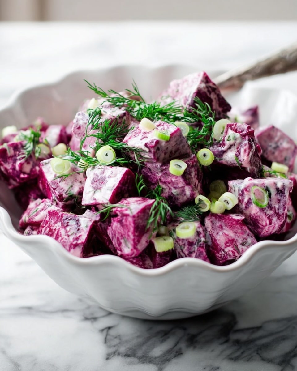 A white scalloped bowl filled with a salad made of bright purple beetroot cubes mixed with a creamy dressing that coats each piece. The salad is topped with small, light green slices of spring onions and fresh sprigs of dark green dill, giving a fresh contrast to the purple beets. The bowl rests on a surface with a white marbled texture. photo taken with an iphone --ar 4:5 --v 7