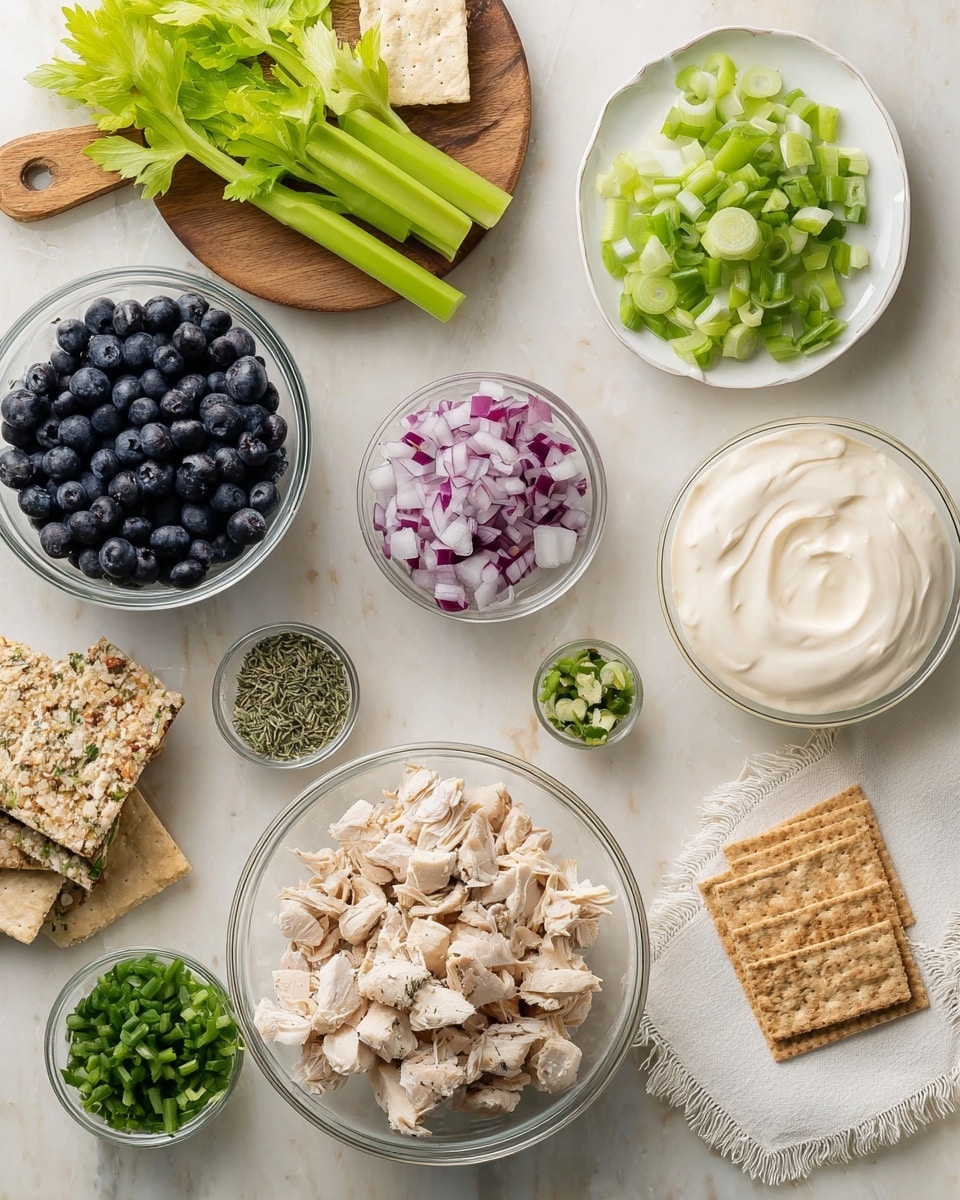 The image shows several clear glass bowls filled with different ingredients arranged on a white marbled surface. From the bottom center, there's a large bowl filled with small, light-colored cooked pieces of chicken. To the right of it, there's a small bowl filled with smooth, creamy white mayo. Above that, a small bowl with bright green chopped green onions is placed near a white plate holding fresh celery stalks and leaves along with a small bowl of finely chopped purple-red onions. On the left side of the image, a medium bowl full of fresh, dark blue blueberries and another bowl with light green chopped celery are visible. A small bowl with dried green herbs is placed on a round wooden board near a white fringed cloth. Some square whole grain crackers are scattered near the mayo and celery plate. Photo taken with an iphone --ar 4:5 --v 7