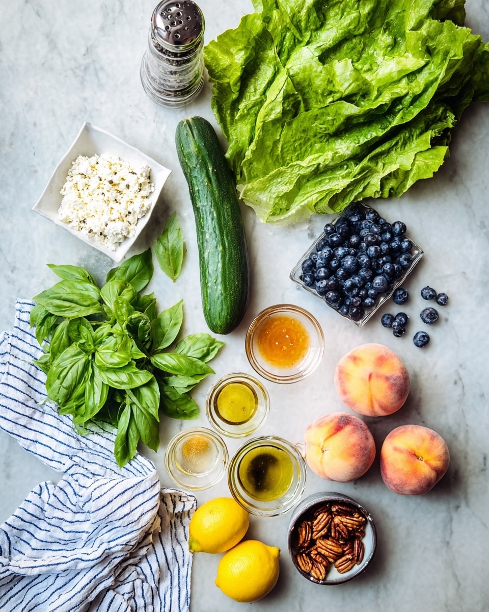 The image shows fresh ingredients arranged on a white marbled surface. At the top right, there is a bunch of bright green leafy lettuce with a long dark green cucumber placed below it. Below the cucumber, there are three round flat peaches with a mix of soft pink and light orange colors. To the left of the peaches, there is a small bowl filled with white crumbled cheese. On the bottom left, there is another bunch of green leafy lettuce. Above that, a small white square bowl holds many dark blue, plump blueberries, some scattered nearby. Center-left features a small bowl of pecans, bright yellow lemons, fresh green basil, and three small glass bowls containing mustard-colored, golden olive oil, and honey-like liquids. At the very top left, a clear pepper grinder with black and white peppercorns rests on a striped white and blue cloth. Photo taken with an iphone --ar 4:5 --v 7