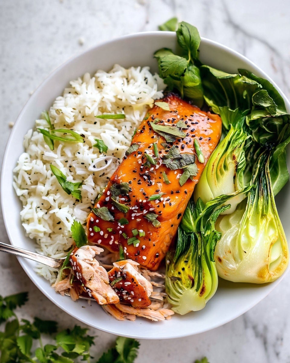 A white bowl holds three main layers: on the left, a fluffy layer of white rice sprinkled with thin green onion slices; in the center, a glazed orange-brown piece of salmon topped with black and white sesame seeds and small green herb pieces, with a fork lifting a portion to show the salmon's pink inside; on the right, two pieces of bright green bok choy with slightly charred edges, all placed on a white marbled surface with green herbs scattered nearby photo taken with an iphone --ar 4:5 --v 7